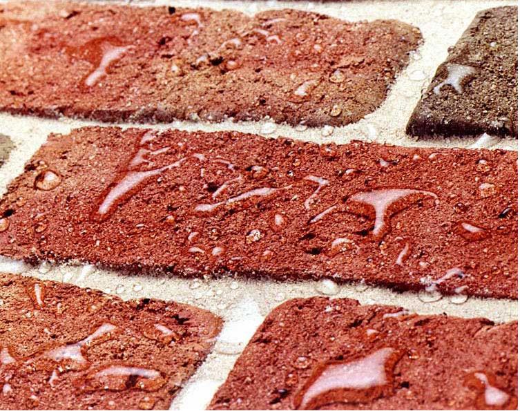 Water beading on red brick treated with a water repellent Water beading on red brick treated with a water repellent